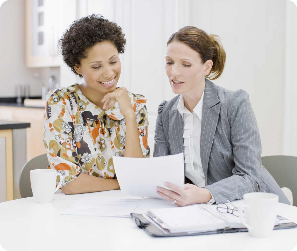 Women reviewing paperwork in an office.